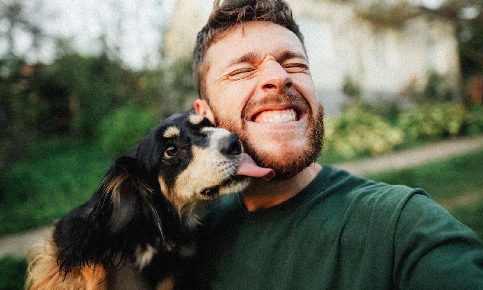 A dog licking their human