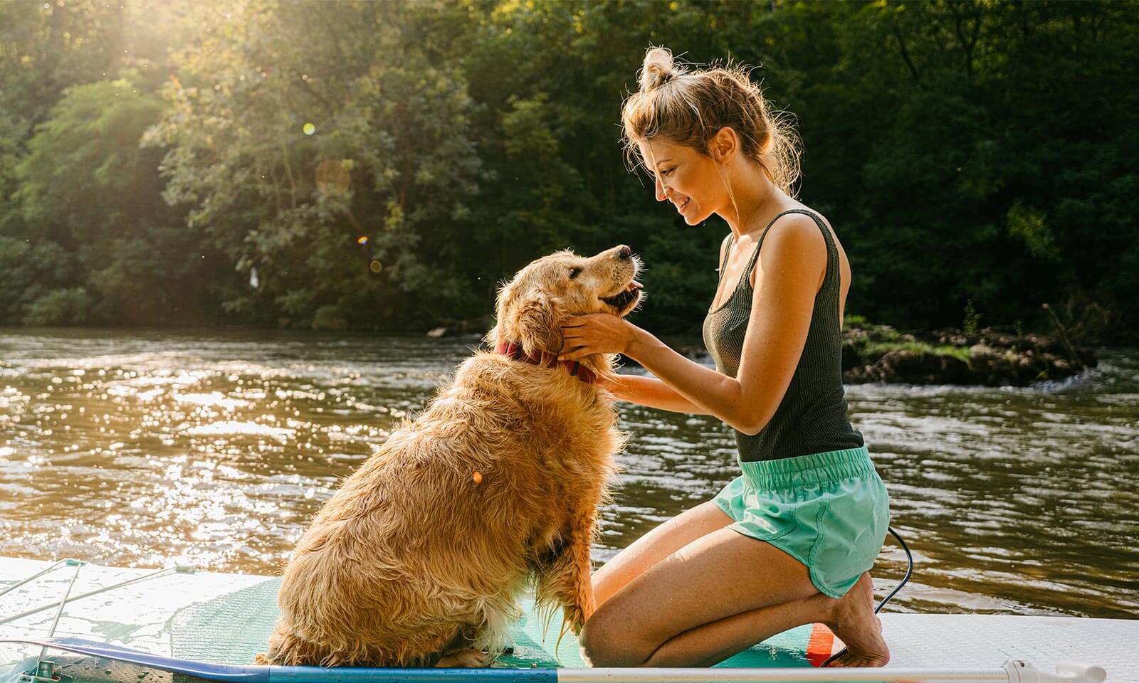 A woman with her dog on the water